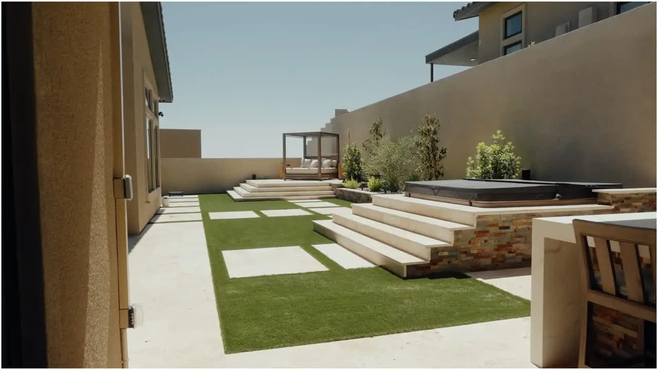 Modern Las Vegas backyard with artificial turf, pavers and stepped patio